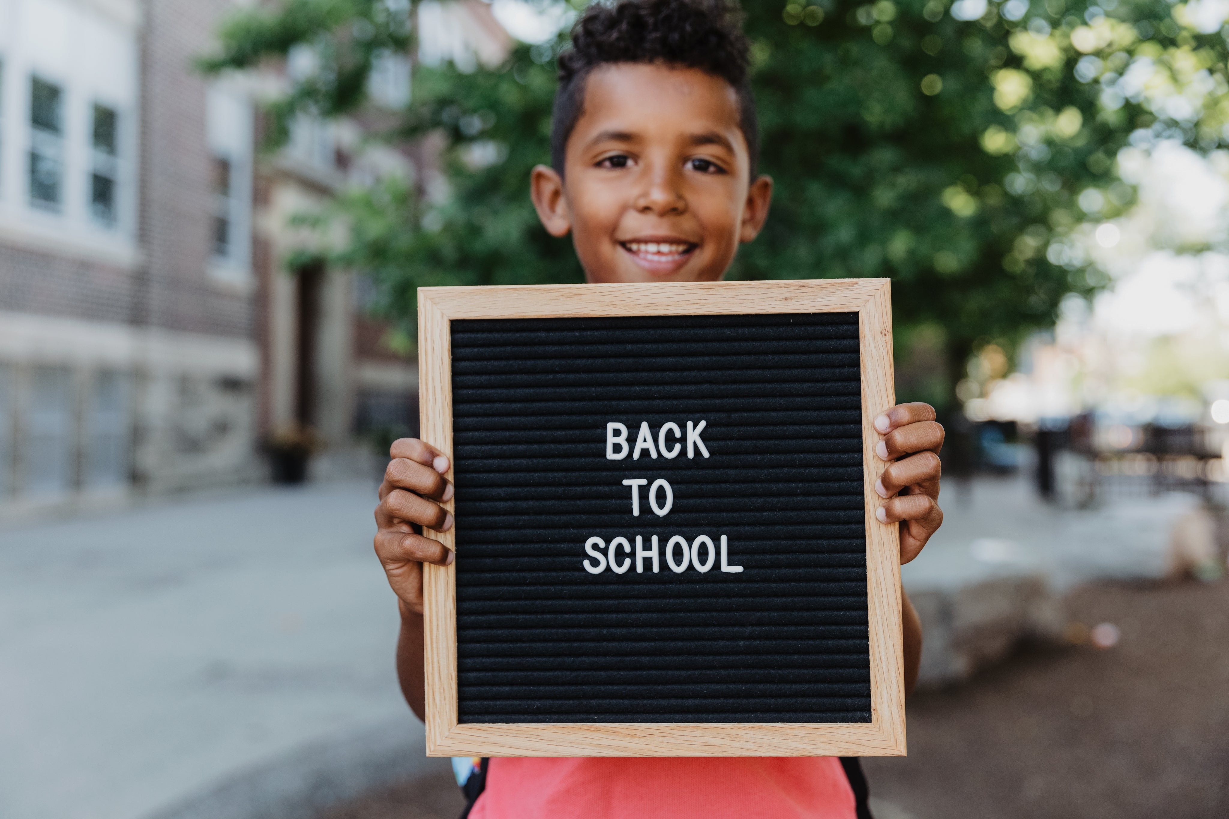 files/boy-holds-back-to-school-pegboard.jpg